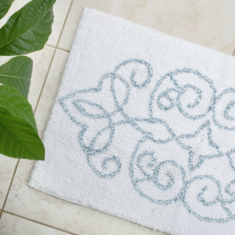 Decorative doormat with floral pattern on a tiled floor