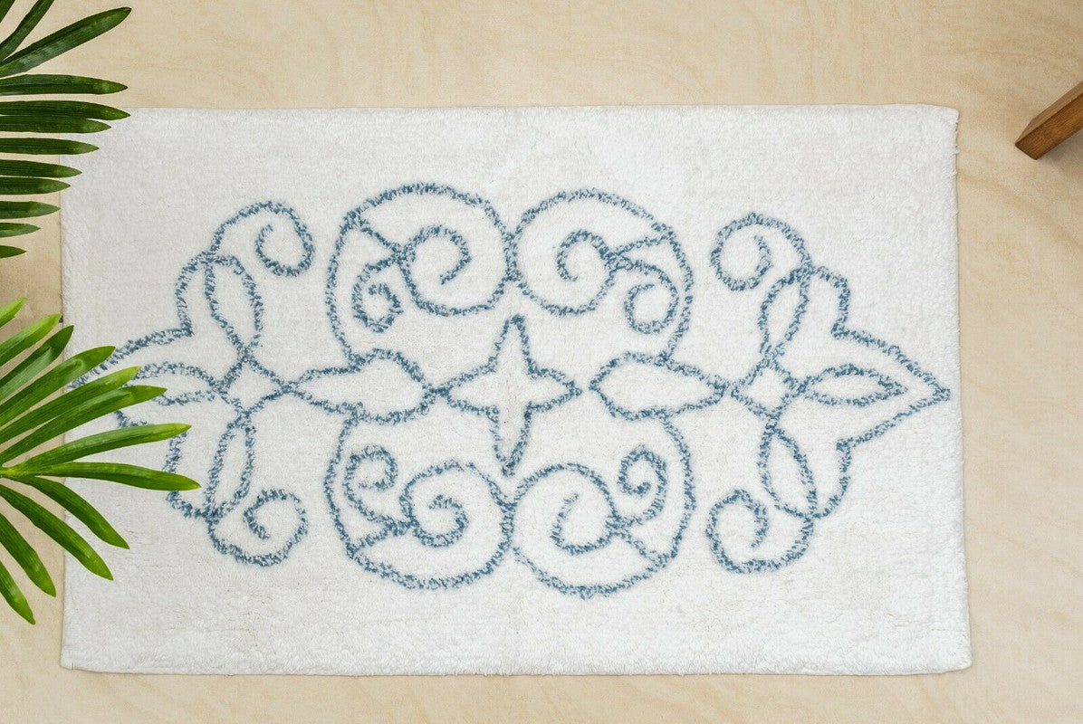 Decorative bath mat with floral pattern on a beige surface