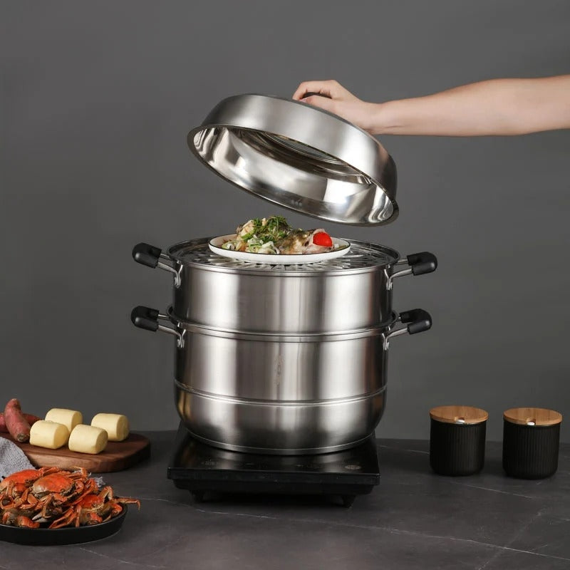 Stainless steel steamer with food on a dark surface