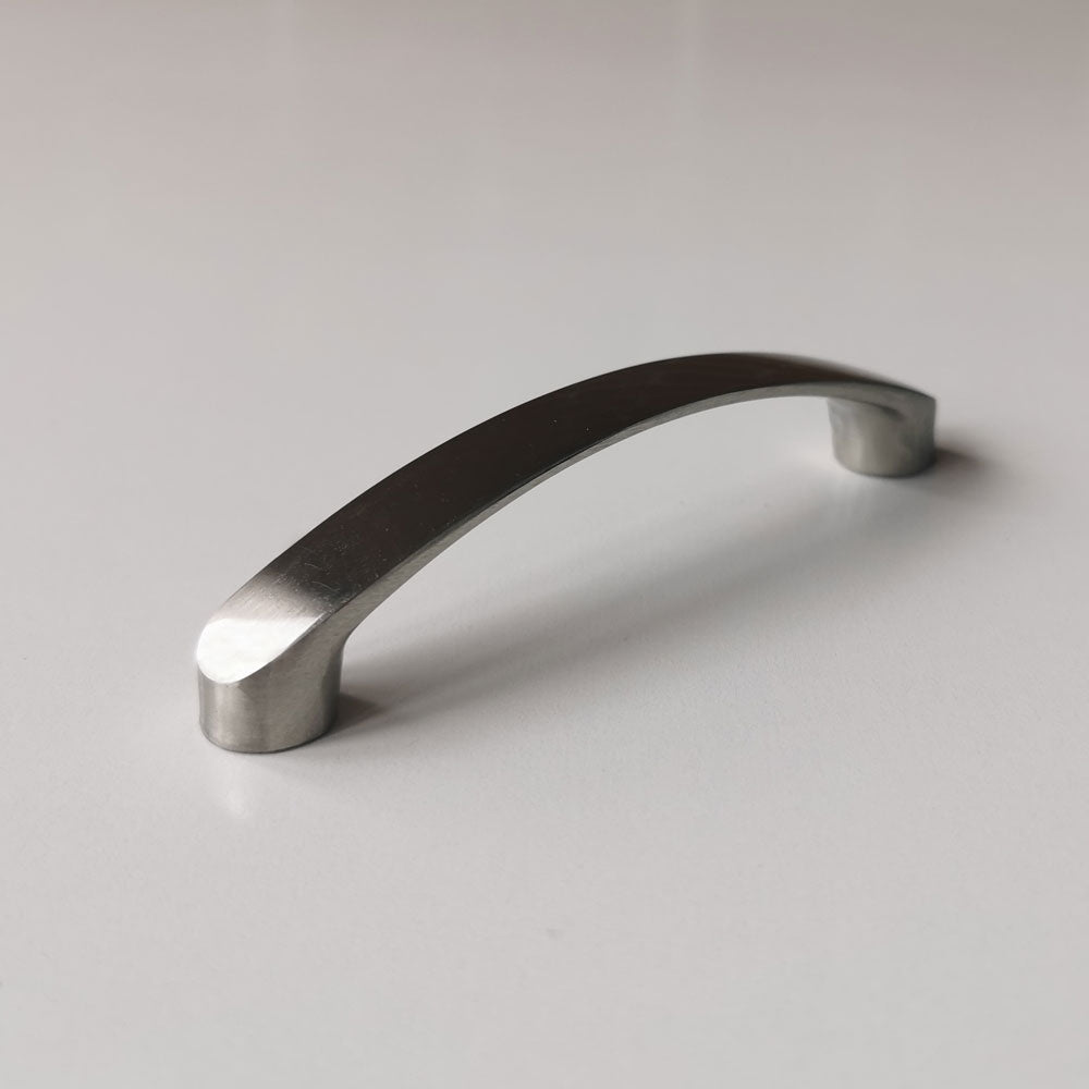 Metallic cabinet handle on a light gray background