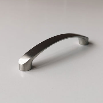 Metallic cabinet handle on a light gray background