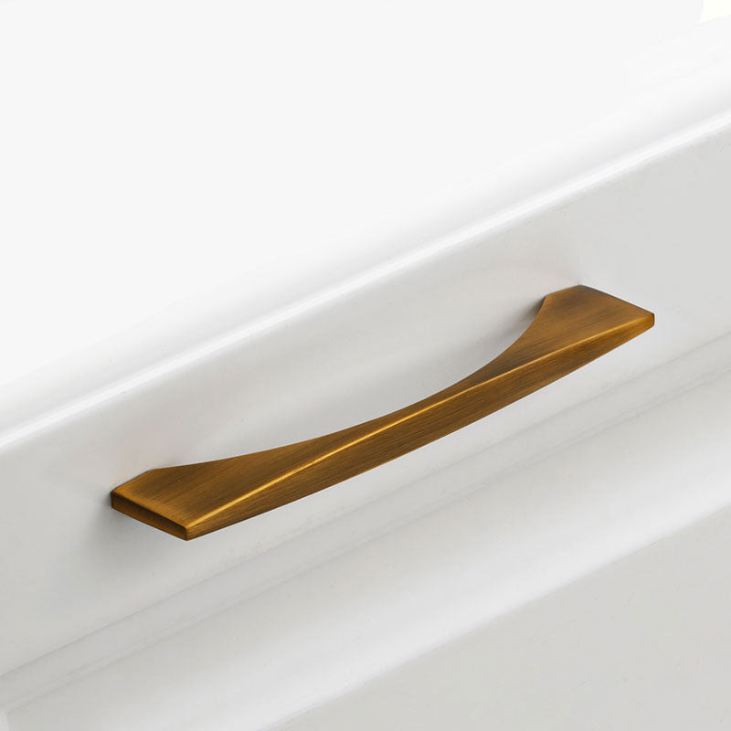 Bronze cabinet handle on a white drawer