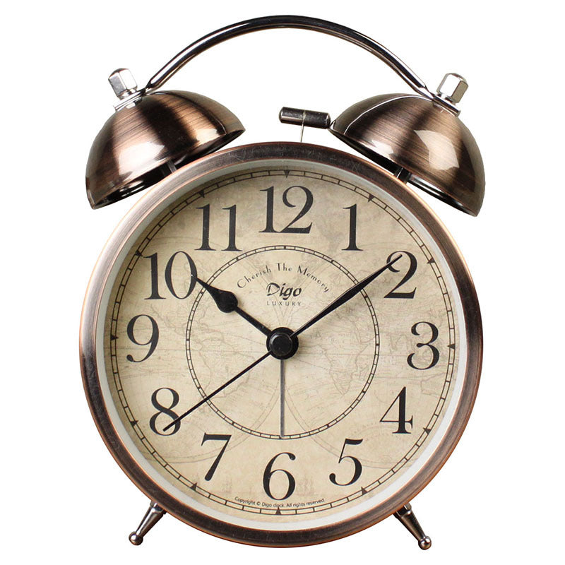 Vintage-style alarm clock with brass finish on a white background