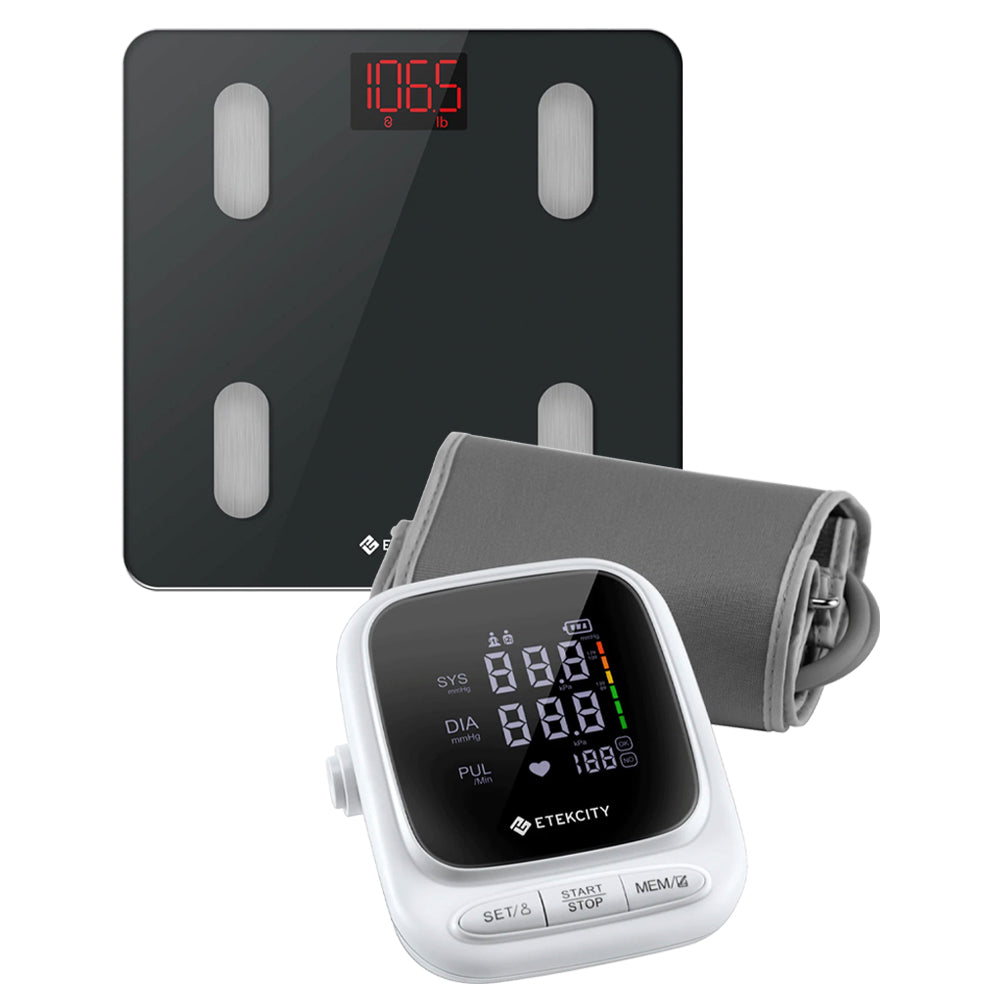Digital blood pressure monitor and scale on a white background