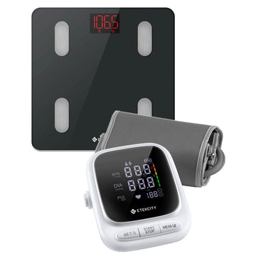 Digital blood pressure monitor and scale on a white background