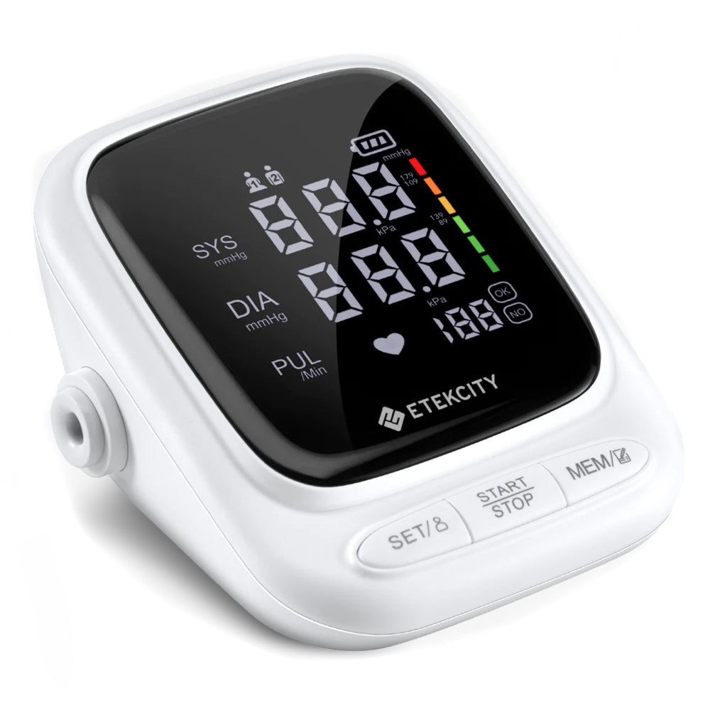 White blood pressure monitor with digital display on a white background