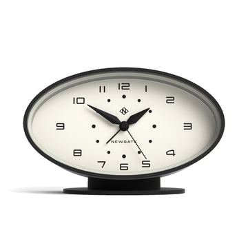 Table clock with black frame and white face on a white background