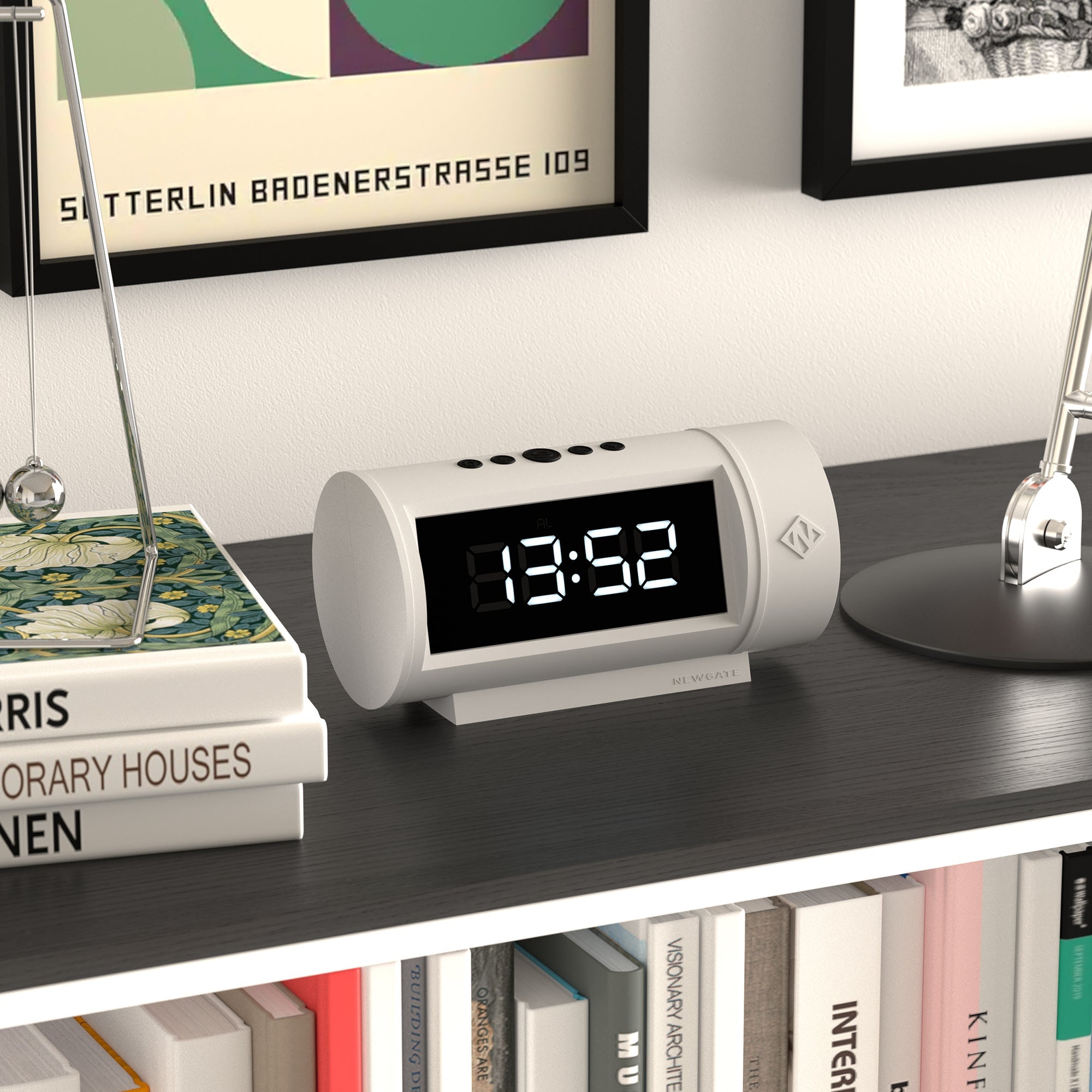 Digital clock on a shelf with books and decorative items