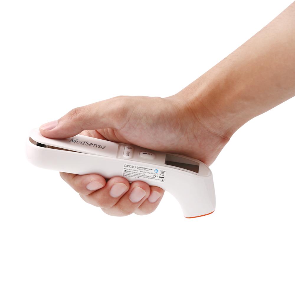 Hand holding a white electronic device labeled 'MedSense' on a white background