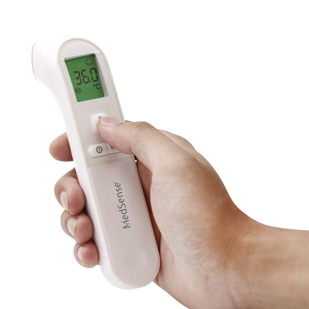 Digital thermometer held in a hand with a white background