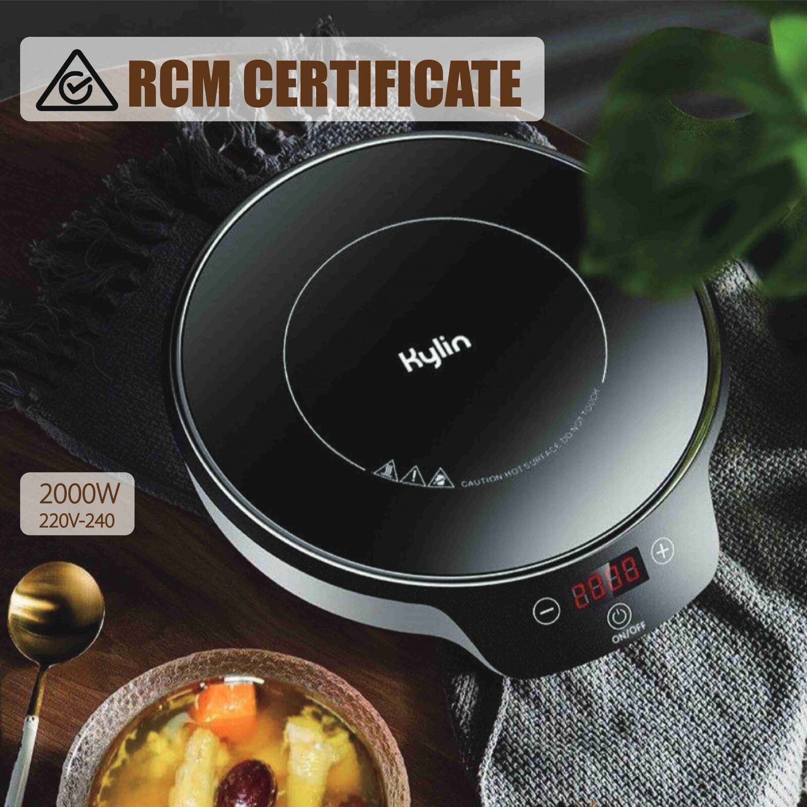 Portable electric stove with Hylin branding on a table with a bowl of soup and spoon, RCM certificate visible.