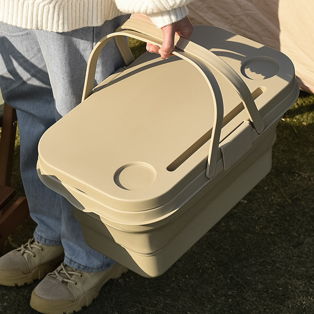 Person holding a beige compost bin outdoors