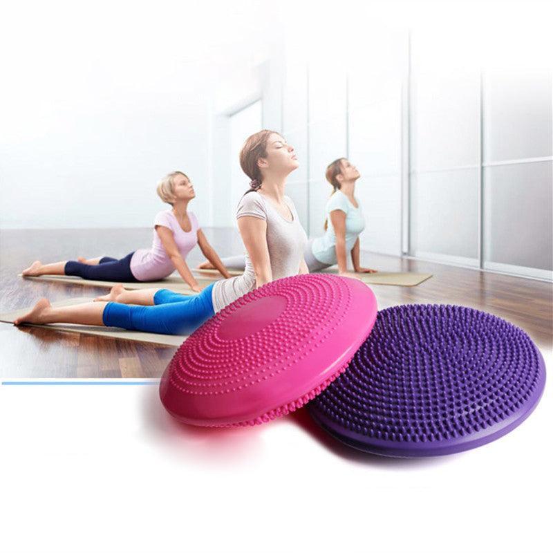 Two exercise discs, one pink and one purple, with a blurred background of people exercising.