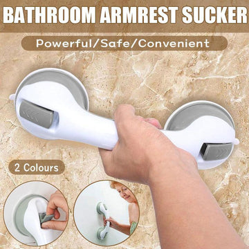 Bathroom armrest sucker with a hand holding it on a tiled wall background.