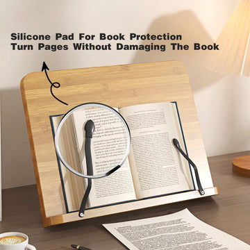 Book stand with magnifying glass and silicone pad for book protection on a wooden surface.