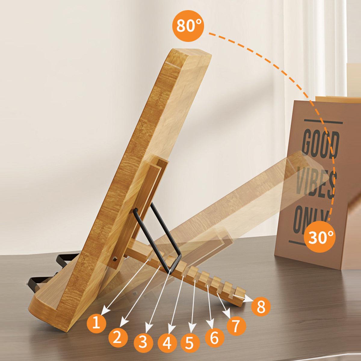 Wooden book stand with adjustable angles on a table, next to a 'Good Vibes Only' card.