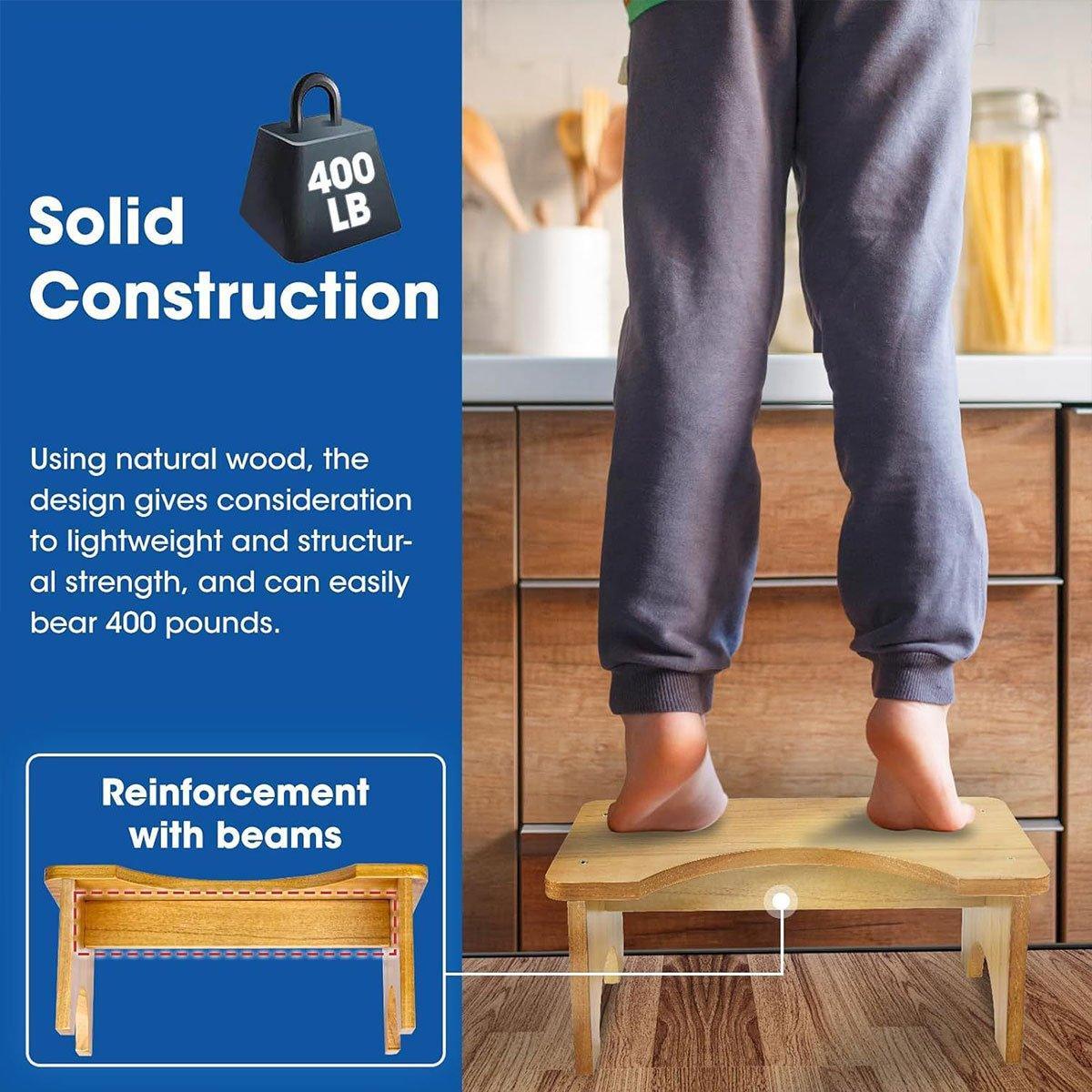 Wooden step stool with text about solid construction and reinforcement with beams, used by a person in a kitchen.