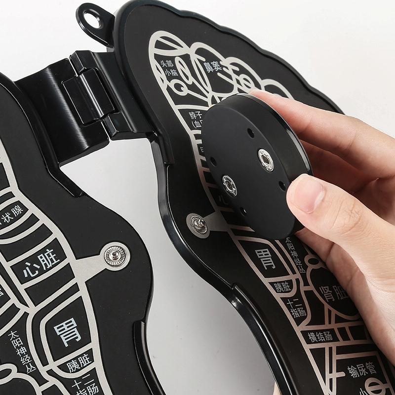 Close-up of a black and white device with Chinese characters, held by a hand.
