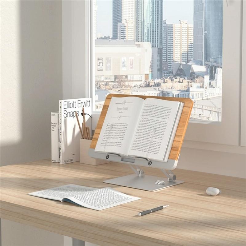 Wooden desk with an open book on a stand, cityscape view through window