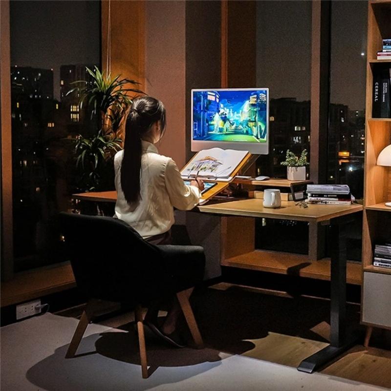 Person sitting at a desk in a dimly lit room, playing a video game on a computer monitor.