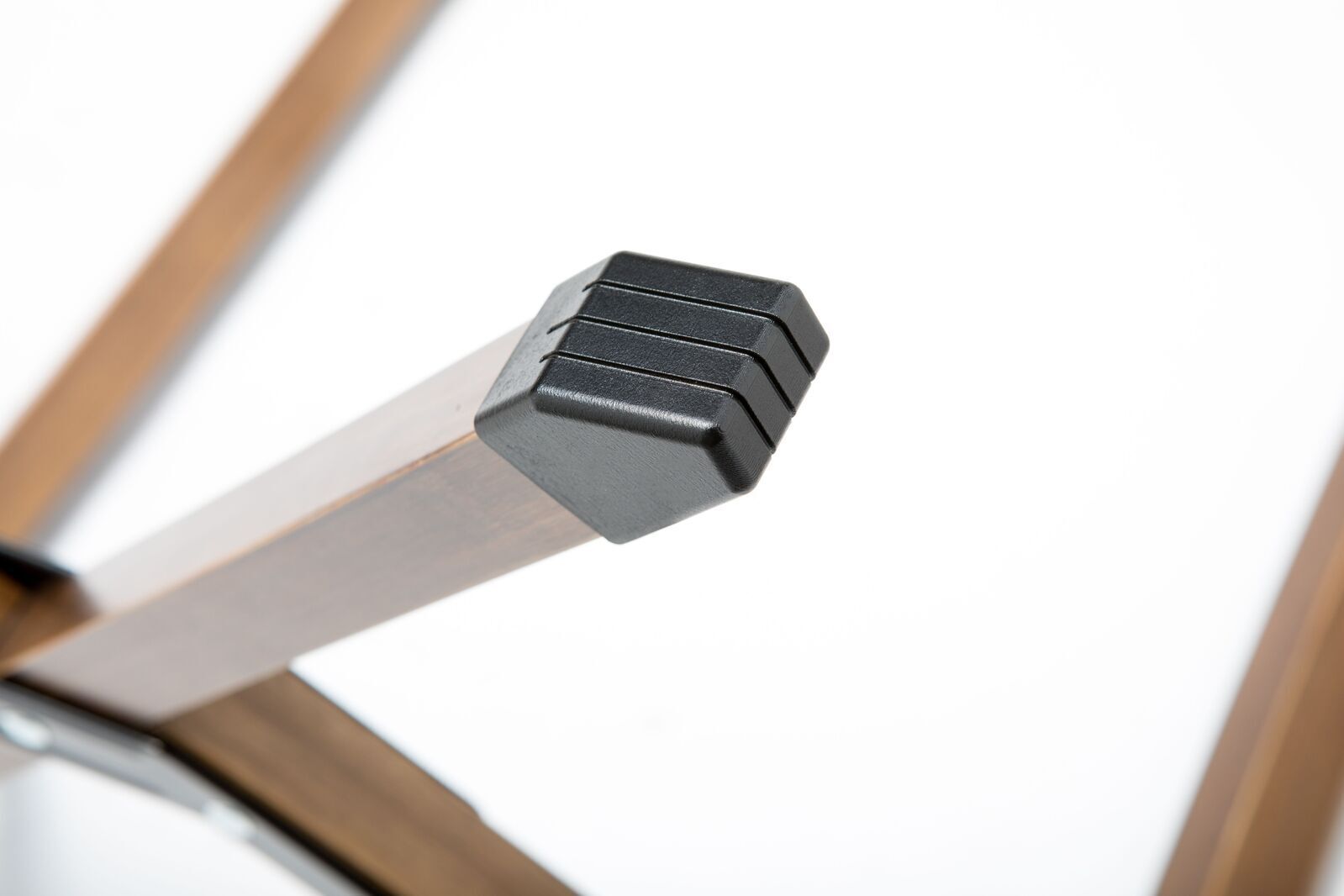 Close-up of a metallic object with a black component on a white background