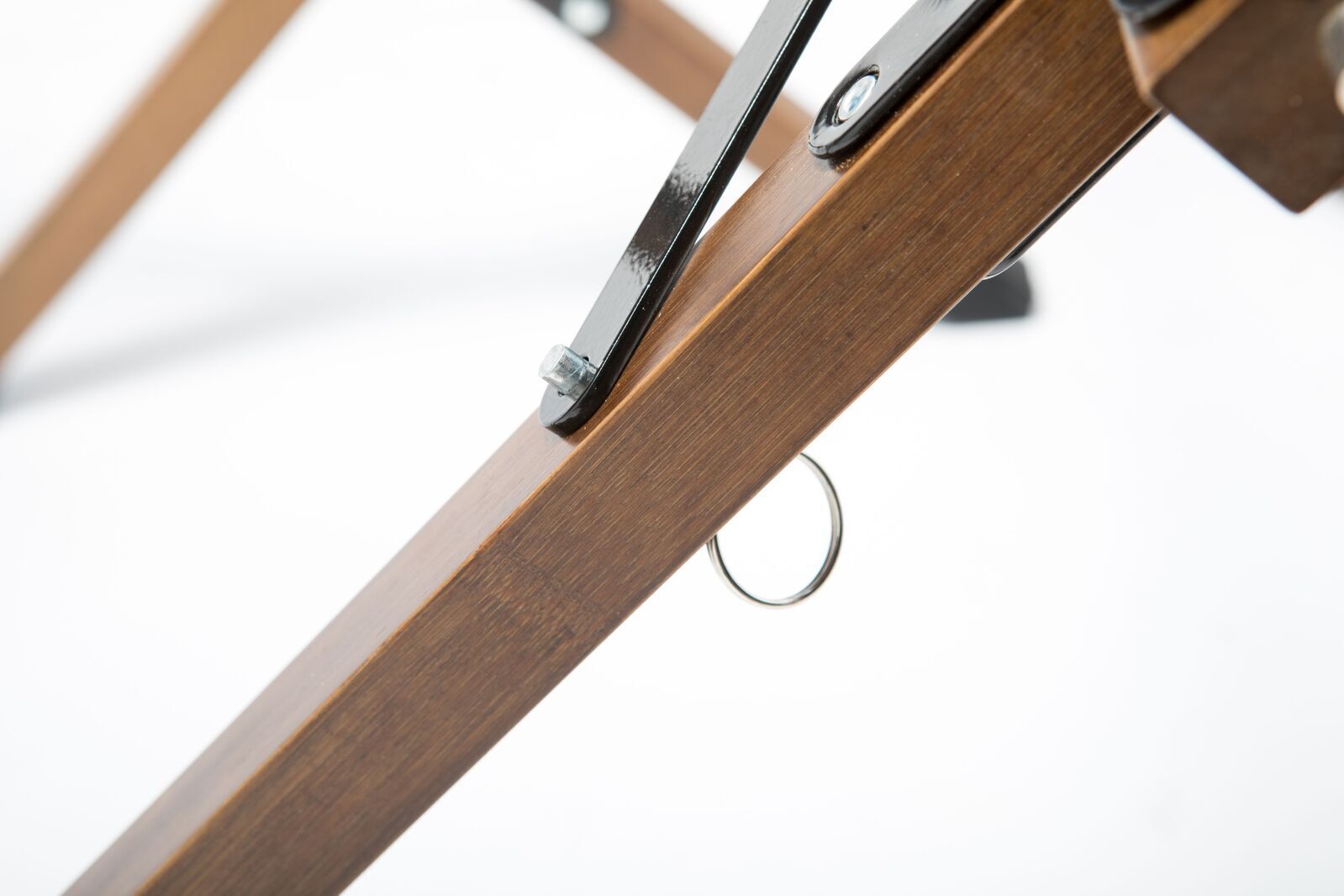 Close-up of a wooden crossbar with metal brackets on a white background