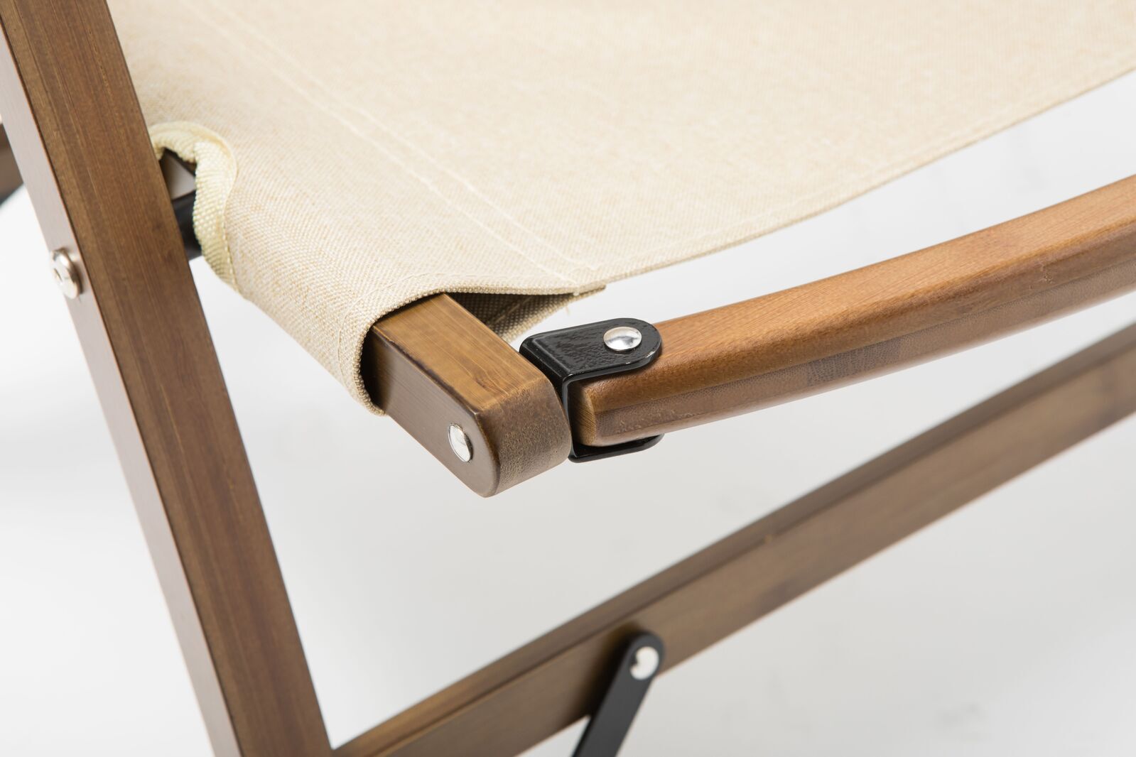 Close-up of a wooden chair with a beige cushion on a white background