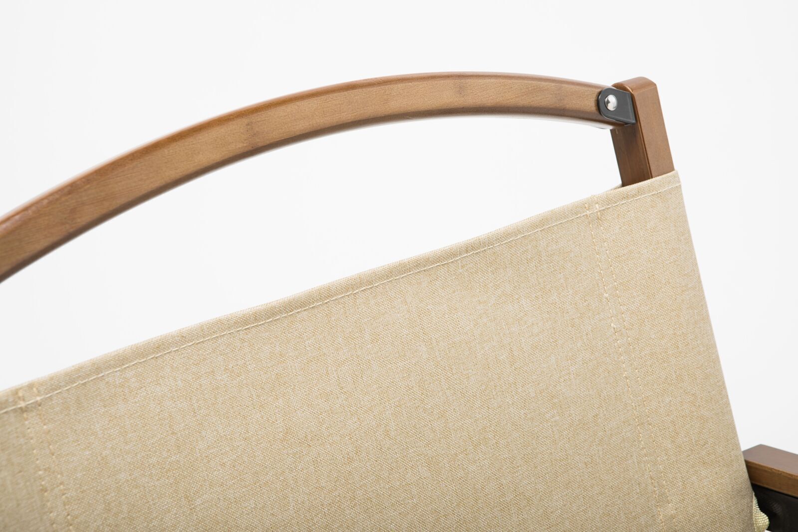 Close-up of a beige cushion on a wooden chair with a white background