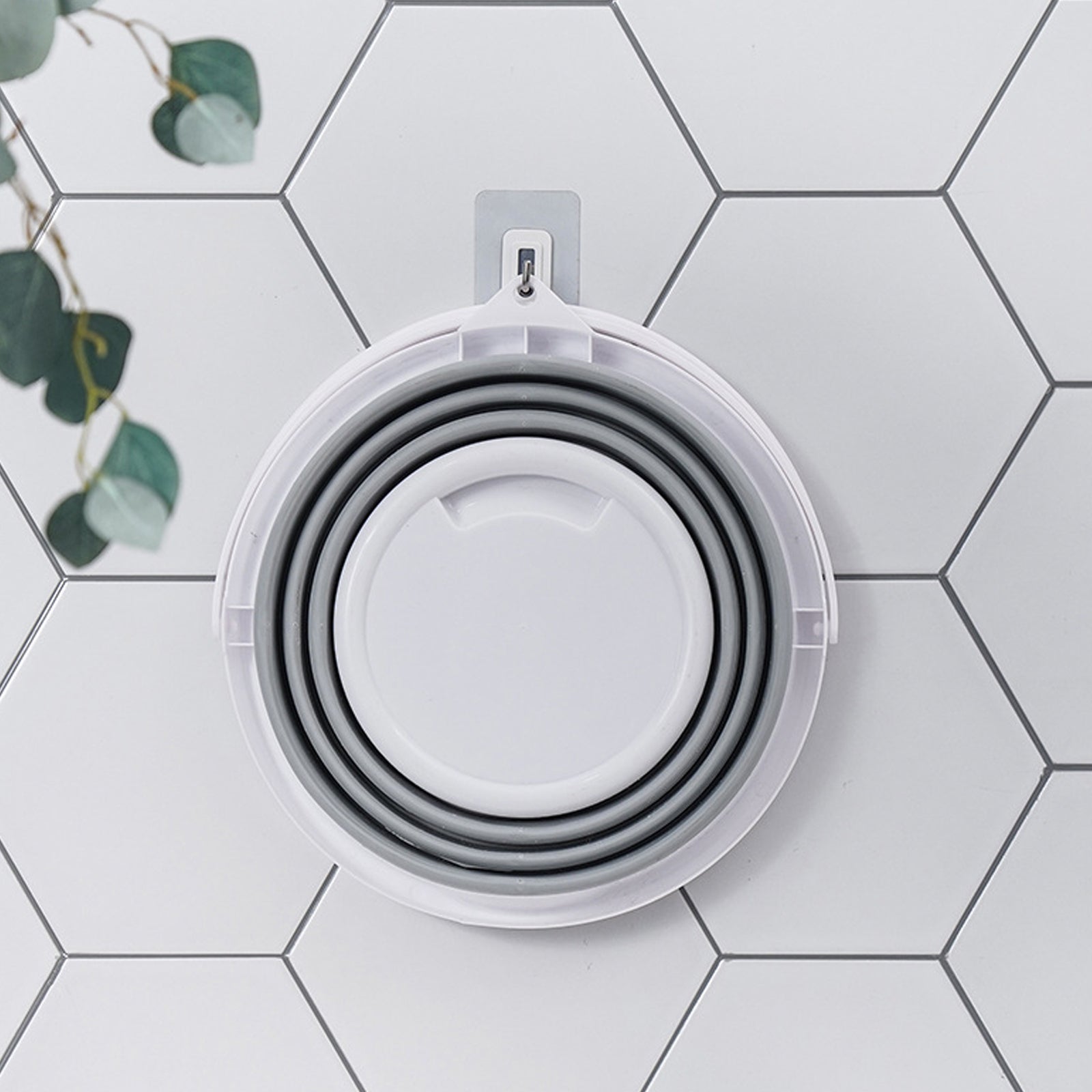 Set of white silicone bowls with lids on a hexagonal tile background