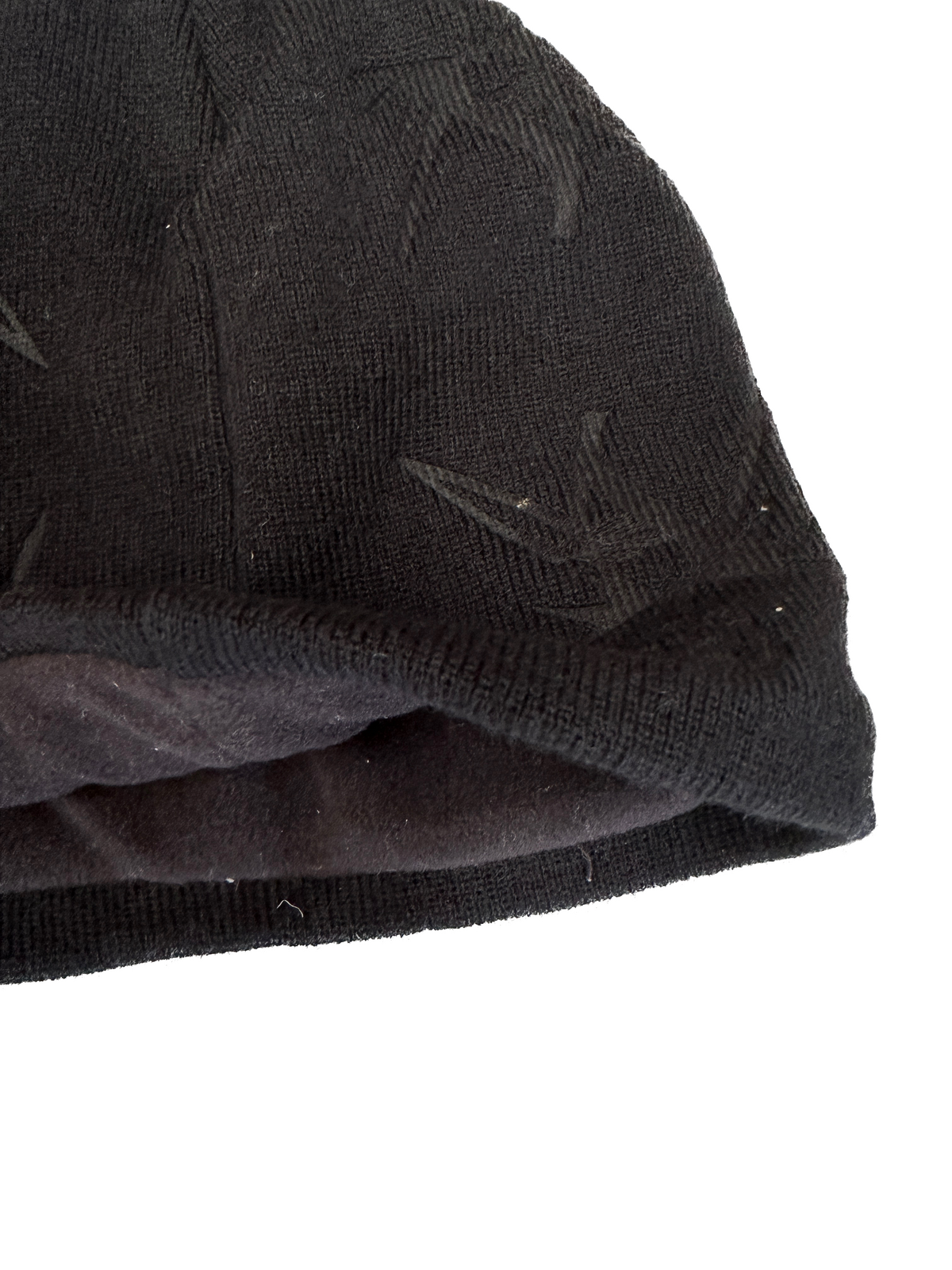 Close-up of a black textured fabric with a white background