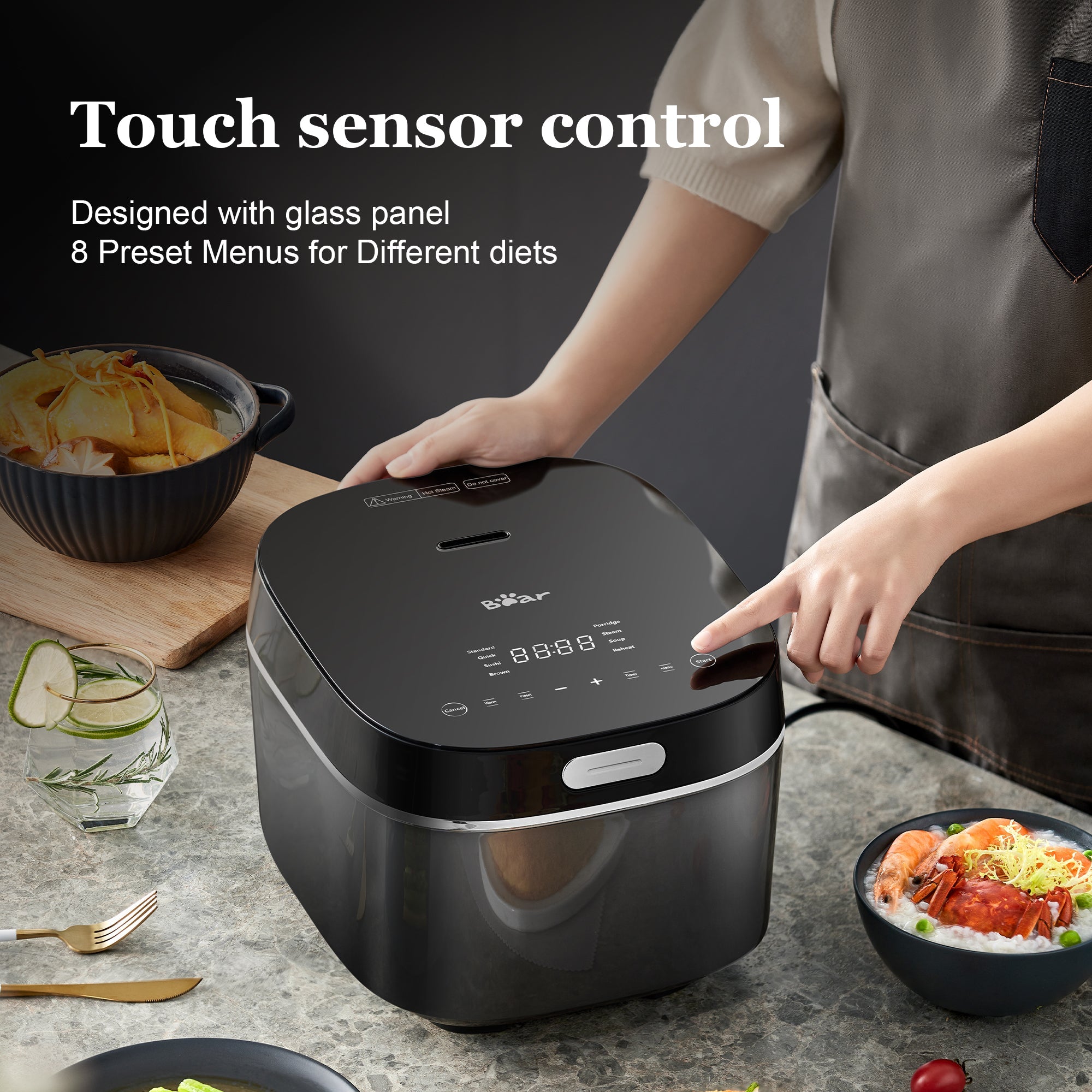 Person using a touch sensor control panel on a modern kitchen setup with food items.