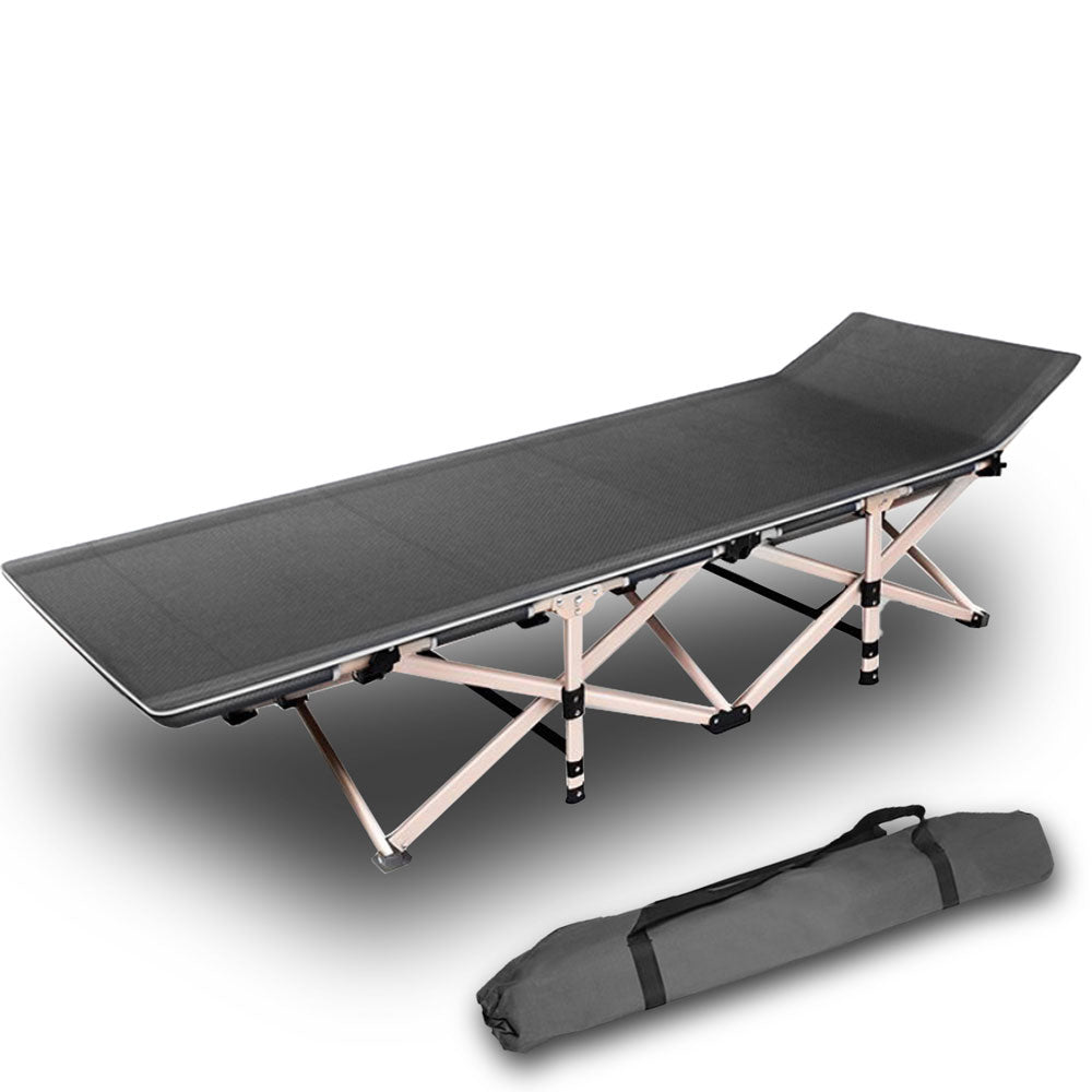 Folding camping bed with carrying bag on a white background