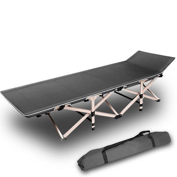 Folding camping bed with carrying bag on a white background