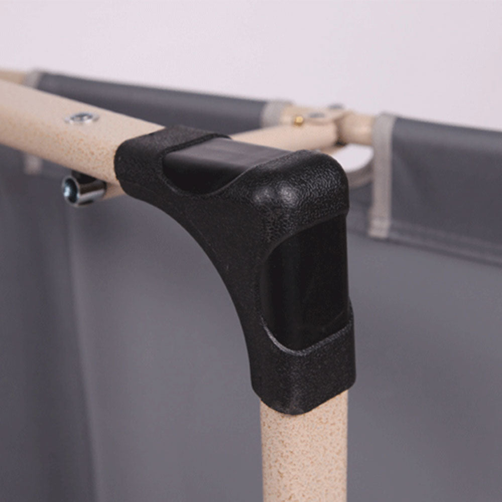 Close-up of a black L-shaped bracket attached to a wooden rod with a gray background.