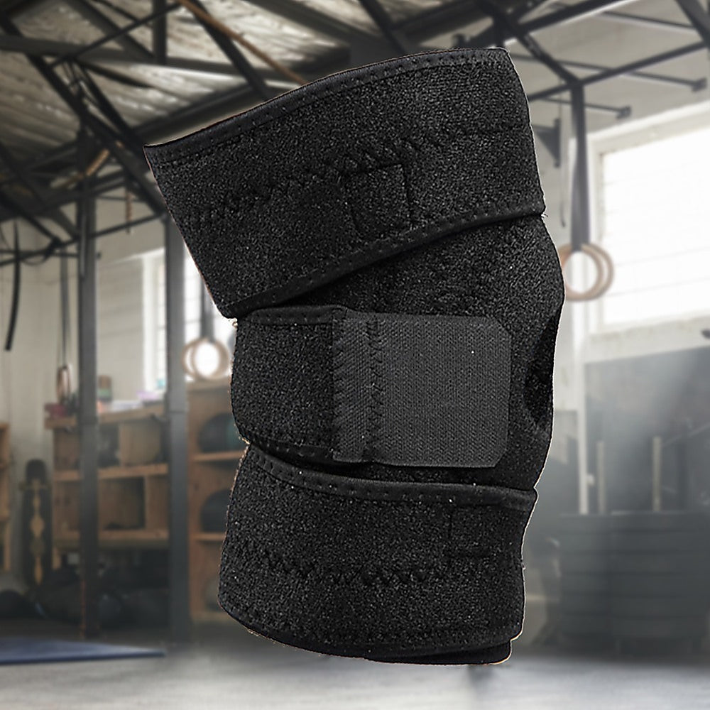 Black knee brace on a blurred gym background