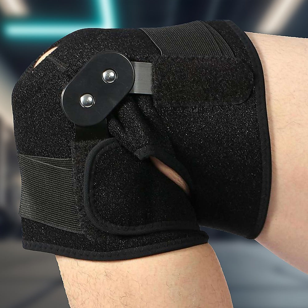 Black wrist support brace on a person's wrist with a blurred background