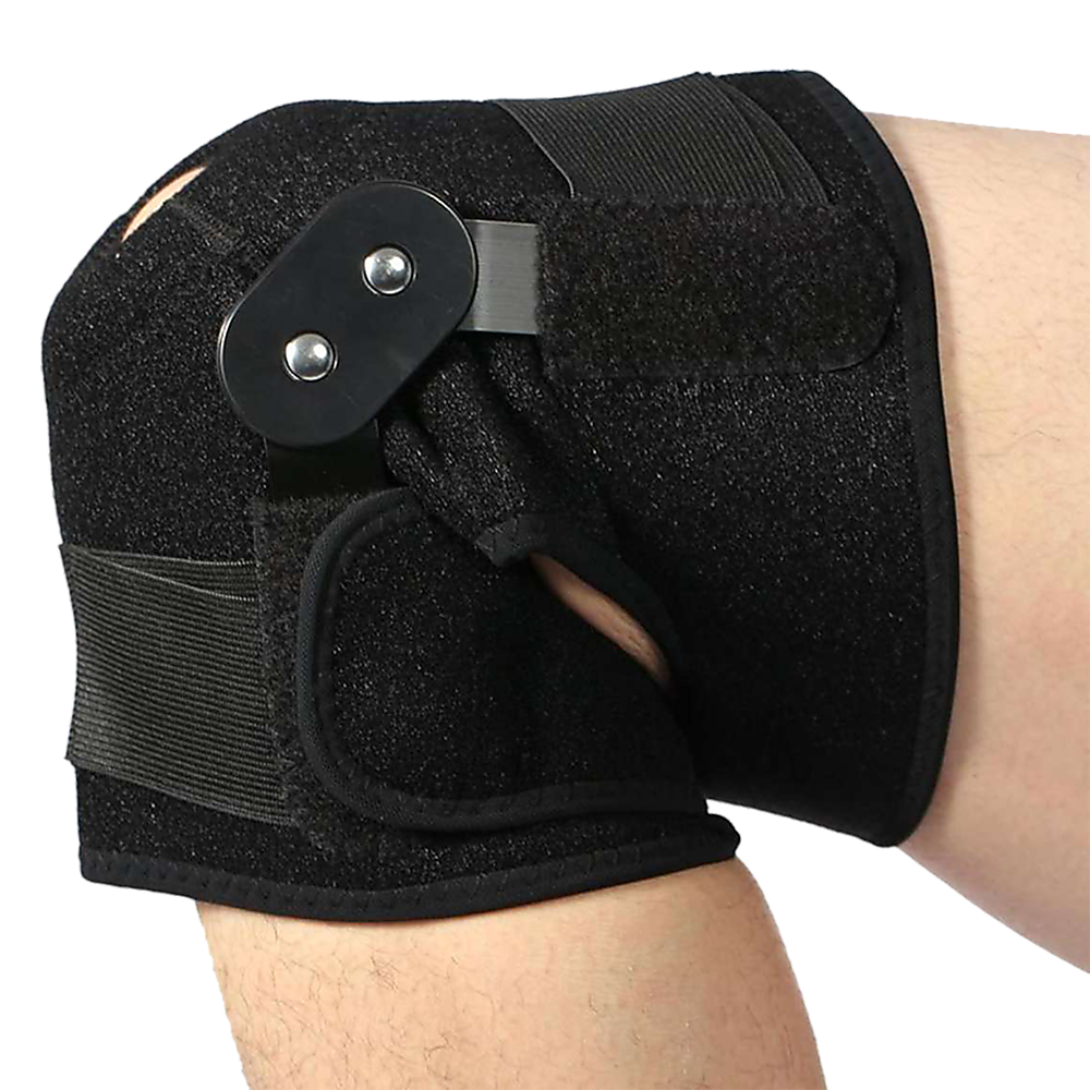 Black knee brace on a person's knee with a white background