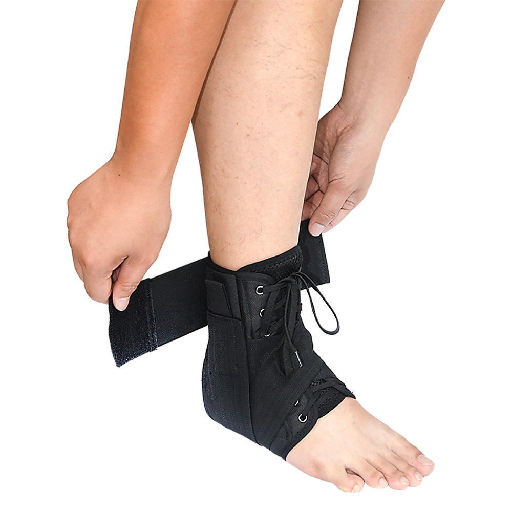 Person wearing a black ankle support brace on a white background