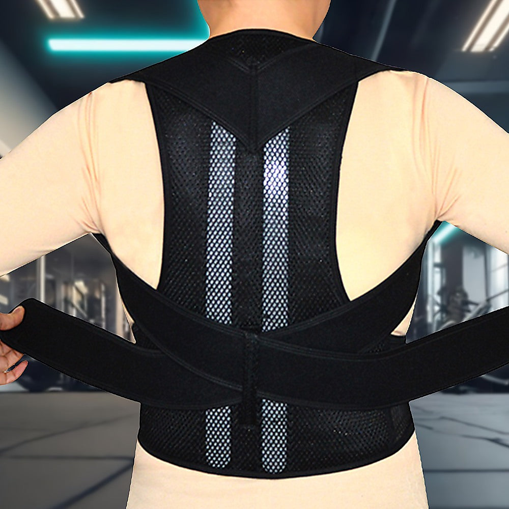 Person wearing a black posture corrector in an indoor setting