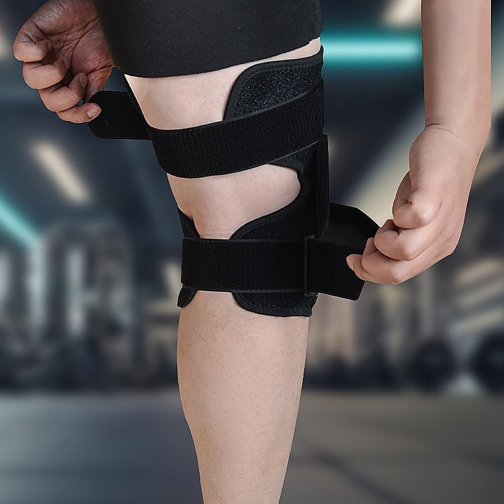 Person wearing a black knee brace with a blurred background