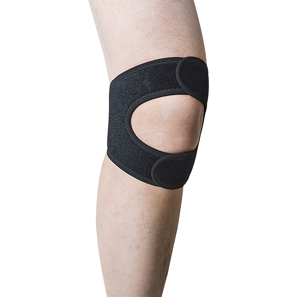 Black knee brace on a person's knee against a white background