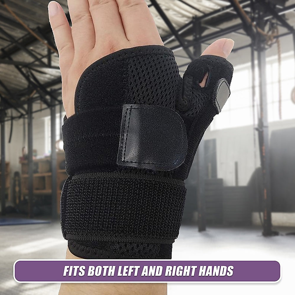 Black wrist support brace on a hand with a blurred indoor background