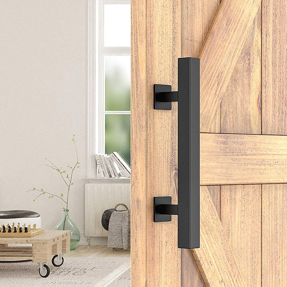 Wooden sliding door with black handle in a room with a radiator and books.