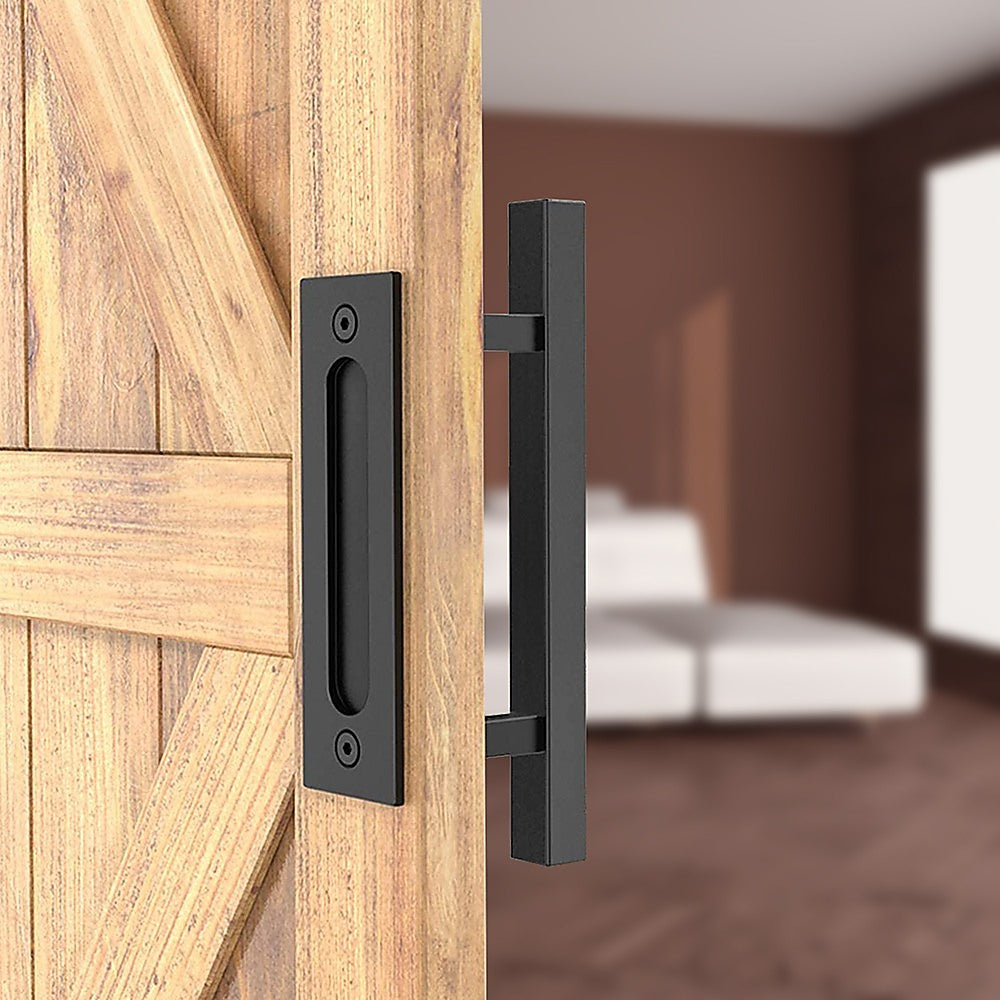 Wooden door with black handle and lock mechanism, blurred bedroom in the background