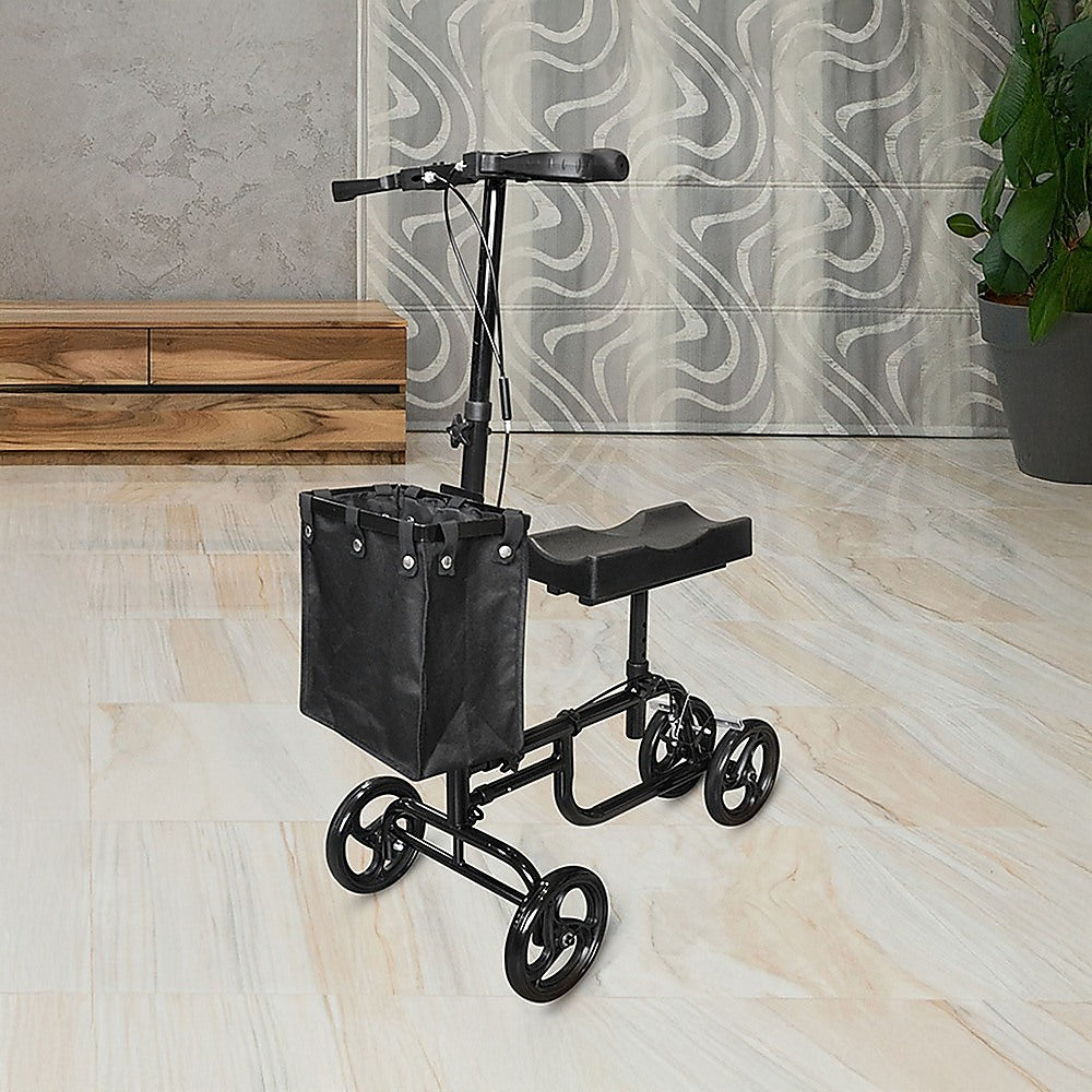 Black knee walker with a basket on a wooden floor.