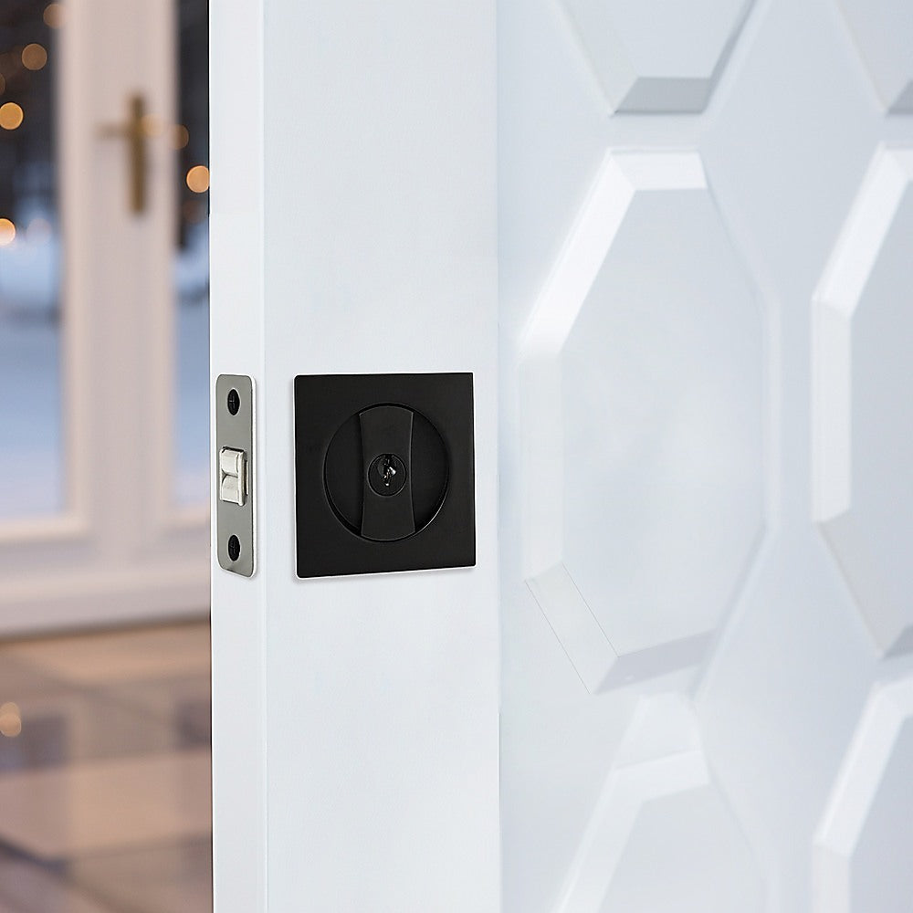 Close-up of a modern door handle on a white door with blurred background