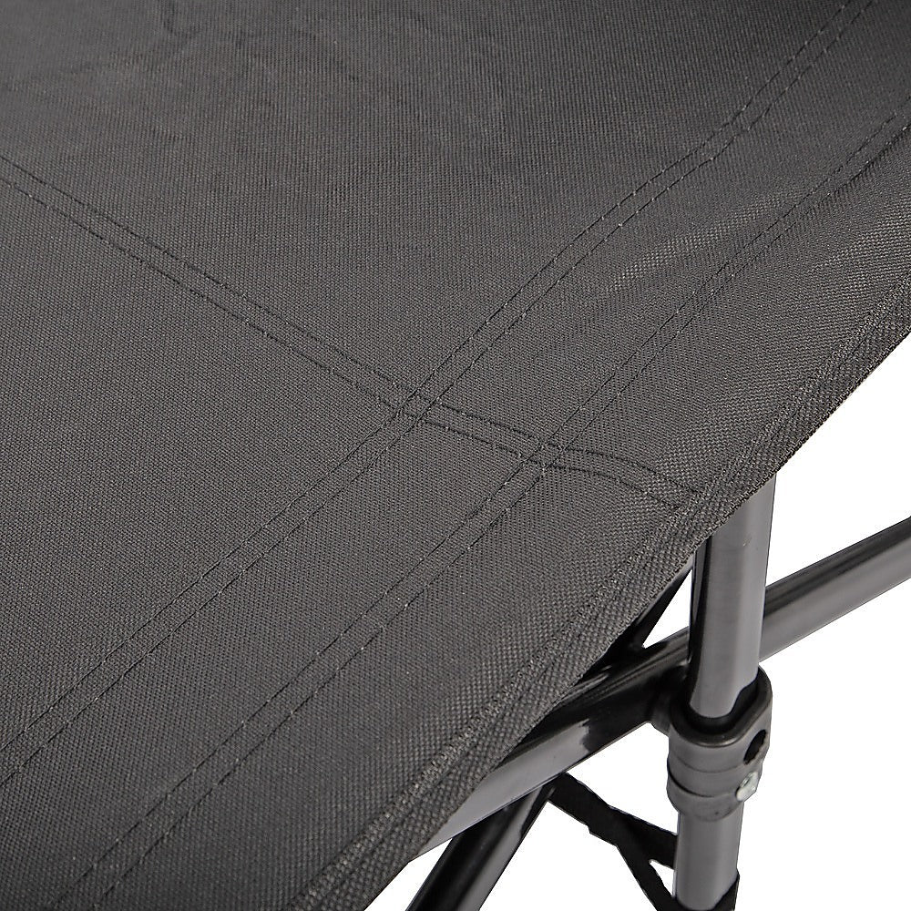 Close-up of a gray camping chair with fabric texture and metal frame.