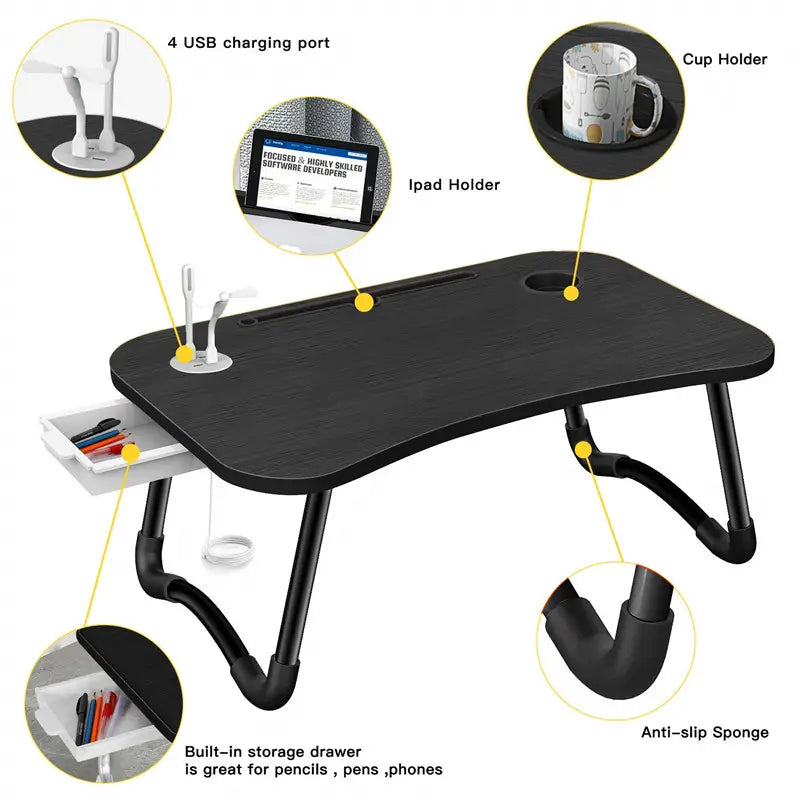 Black adjustable desk with features highlighted, including USB charging port, cup holder, iPad holder, storage drawer, and anti-slip sponge.