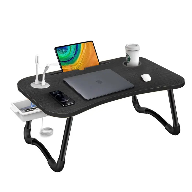 Black adjustable laptop desk with a laptop, cup, and other items on a white background