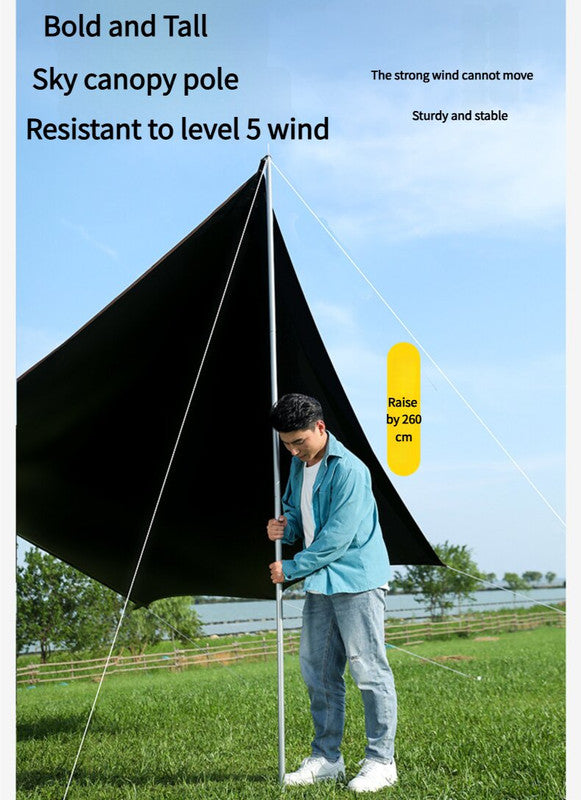 Person setting up a large black canopy with text on a blue sky background